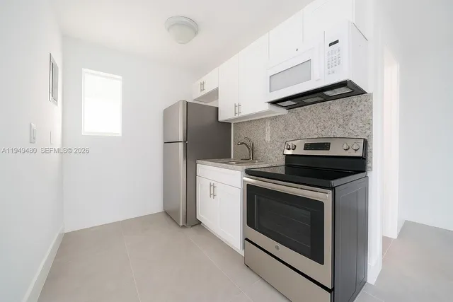 a kitchen with a stove and a microwave