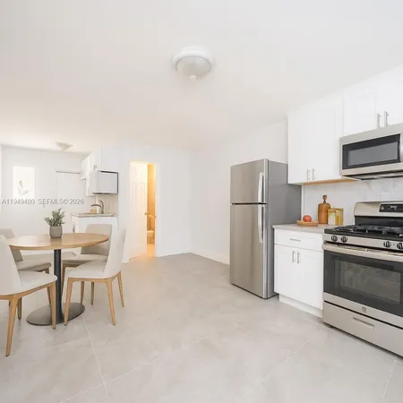a kitchen with stainless steel appliances a refrigerator stove and a sink