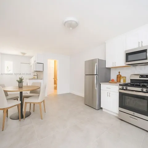 a kitchen with stainless steel appliances a refrigerator stove and a sink