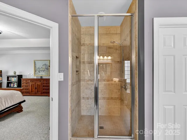 a bathroom with a glass shower door