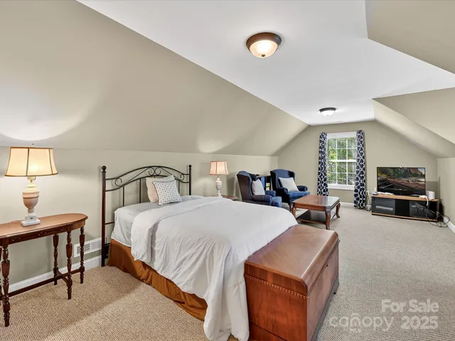 a large bedroom with bed and window