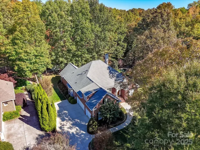 an aerial view of residential house with outdoor space and trees