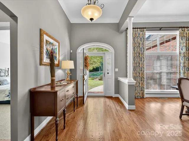 a workspace with wooden floor and a large window