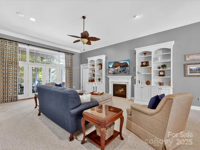 a living room with furniture a fireplace and a window