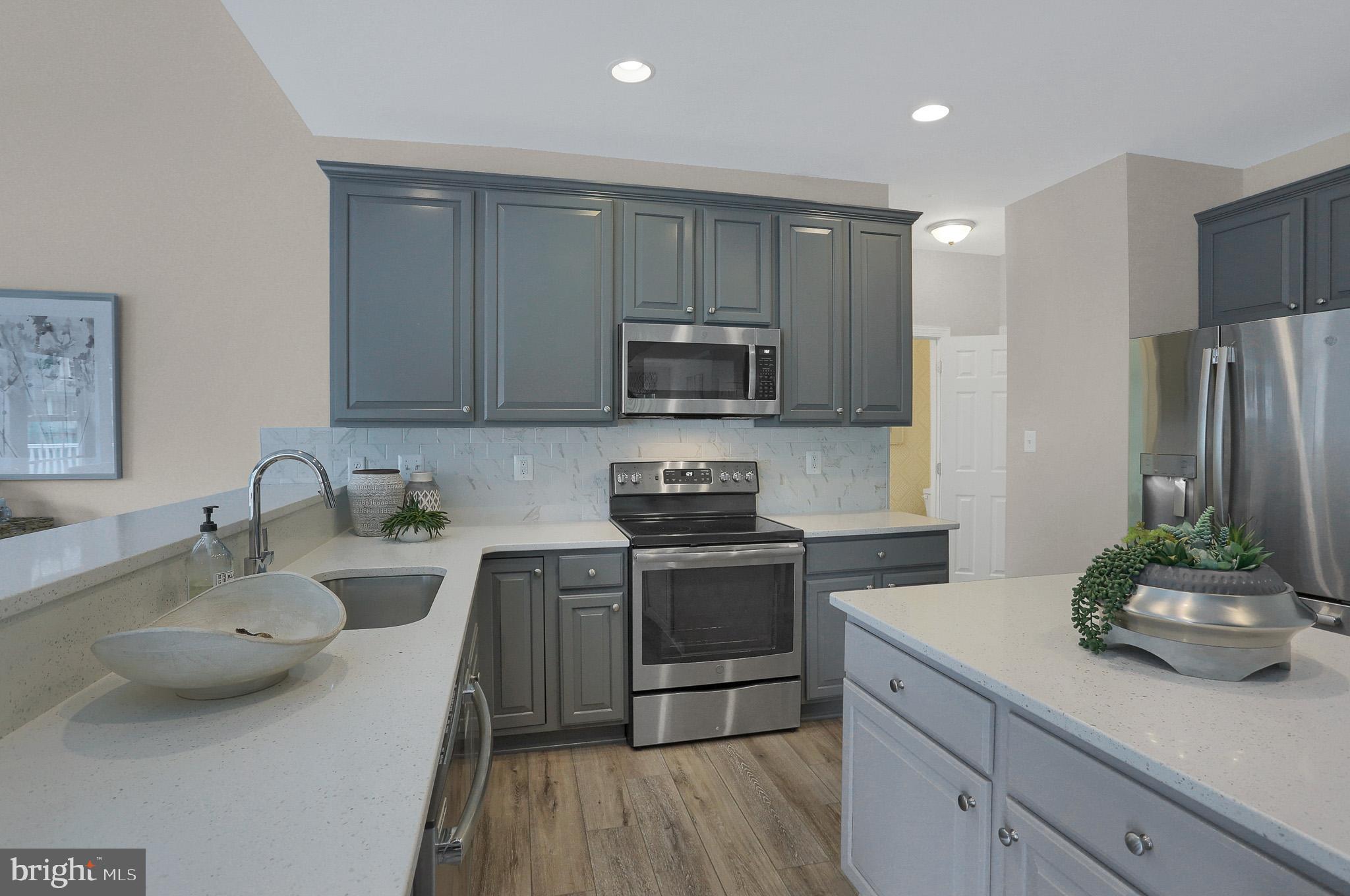 1205 Van Bibber Road Edgewood, MD 21040 - Photo 11 of 17 a kitchen with stainless steel appliances granite countertop a sink stove and refrigerator