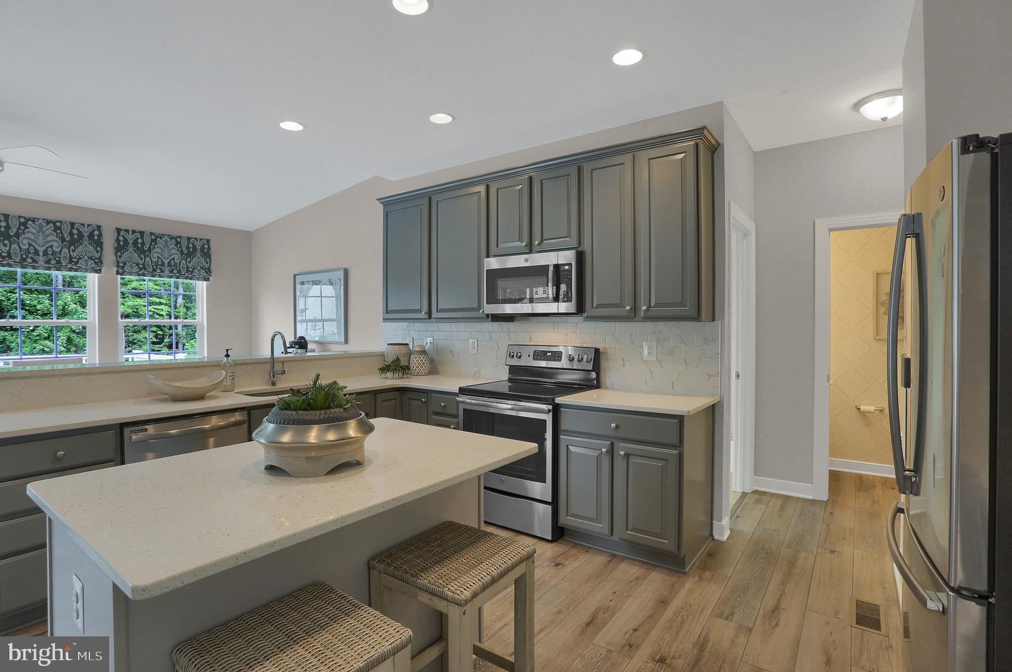 1205 Van Bibber Road Edgewood, MD 21040 - Photo 12 of 17 a kitchen with a sink a stove a refrigerator cabinets and a dining table