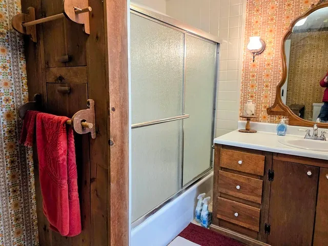 a bathroom with a double vanity sink a mirror and a shower