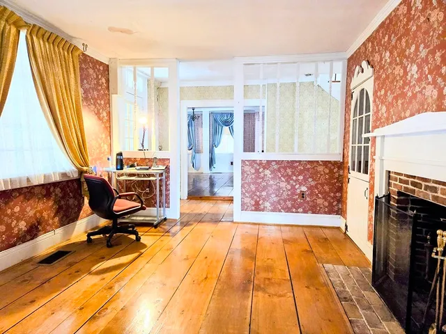 a living room with a fireplace furniture and a window