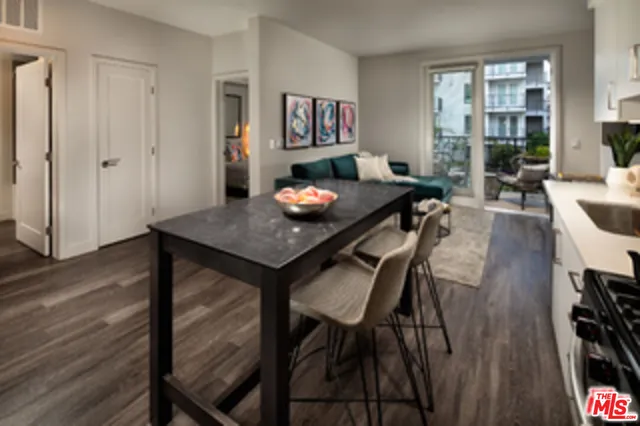a kitchen with a table chairs microwave and cabinets
