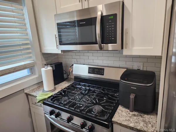 a kitchen with stainless steel appliances granite countertop a stove and a sink
