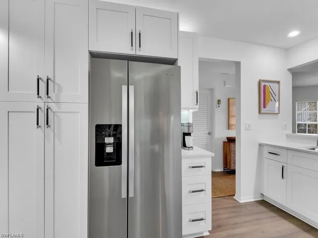 a kitchen with stainless steel appliances a refrigerator and cabinets