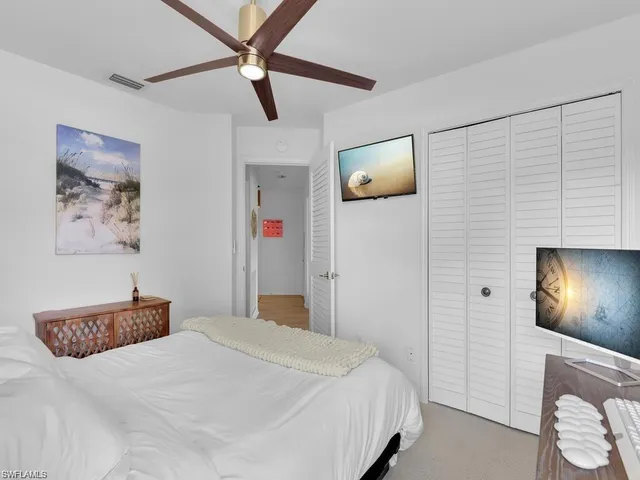 a bedroom with a bed and a lamp