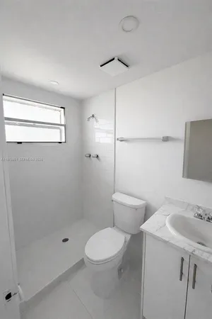 a bathroom with a toilet sink and shower