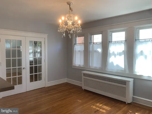 a living room with hardwood floor and windows