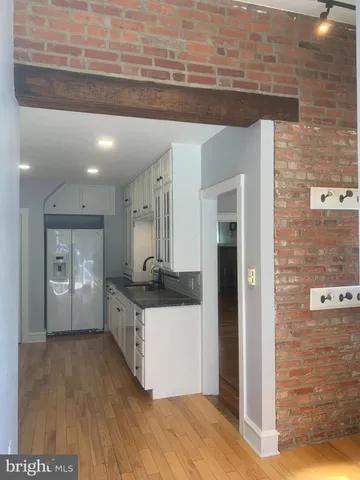a kitchen with stainless steel appliances a refrigerator and a stove