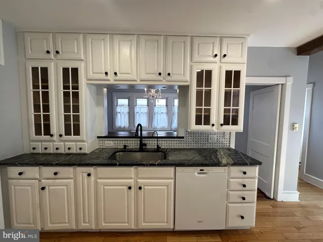a kitchen with stainless steel appliances granite countertop a sink and cabinets