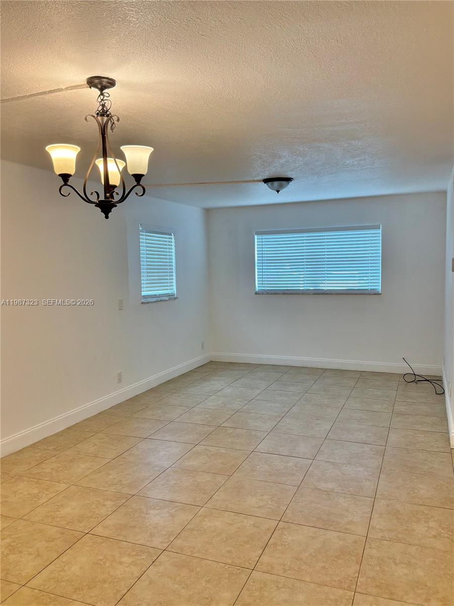 550 Southwest 2nd Avenue, Unit 1210 Boca Raton, FL 33432 - Photo 5 of 18 a view of a livingroom with a chandelier