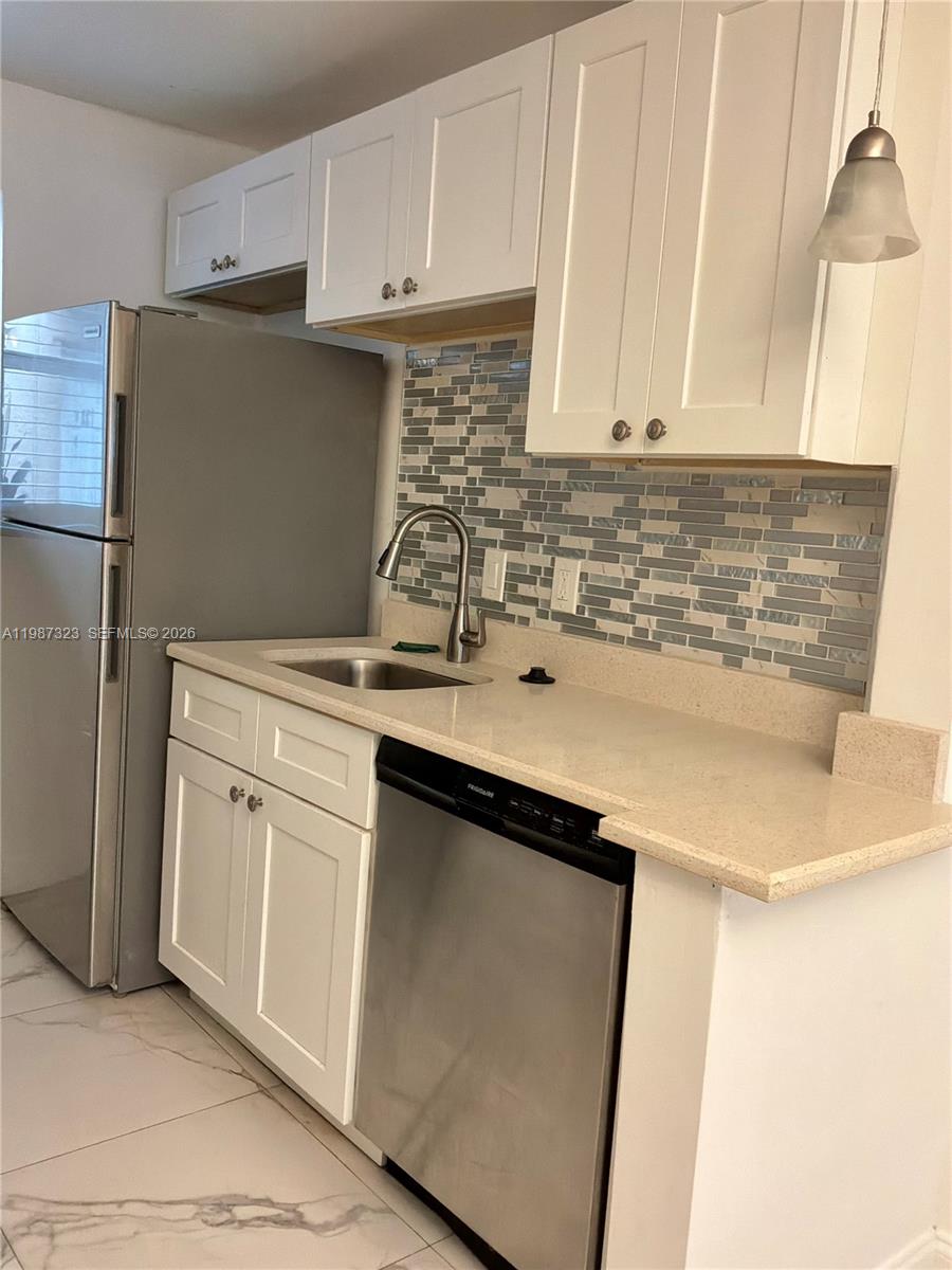 550 Southwest 2nd Avenue, Unit 1210 Boca Raton, FL 33432 - Photo 7 of 18 a kitchen with stainless steel appliances granite countertop a sink stove and refrigerator