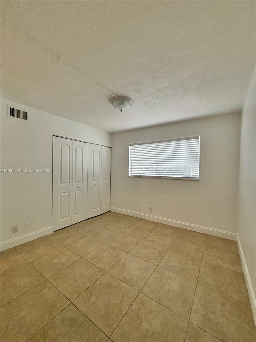 550 Southwest 2nd Avenue, Unit 1210 Boca Raton, FL 33432 - Photo 9 of 18 a view of an empty room with a window