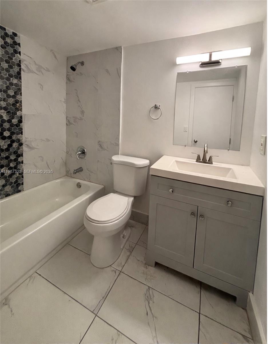 550 Southwest 2nd Avenue, Unit 1210 Boca Raton, FL 33432 - Photo 10 of 18 a bathroom with a sink toilet and shower