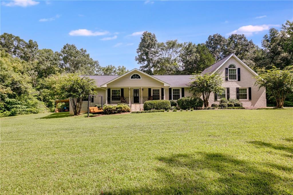 3904 Cave Spring Road Southwest Rome, GA 30161 - Photo 1 of 1 a front view of a house with a garden