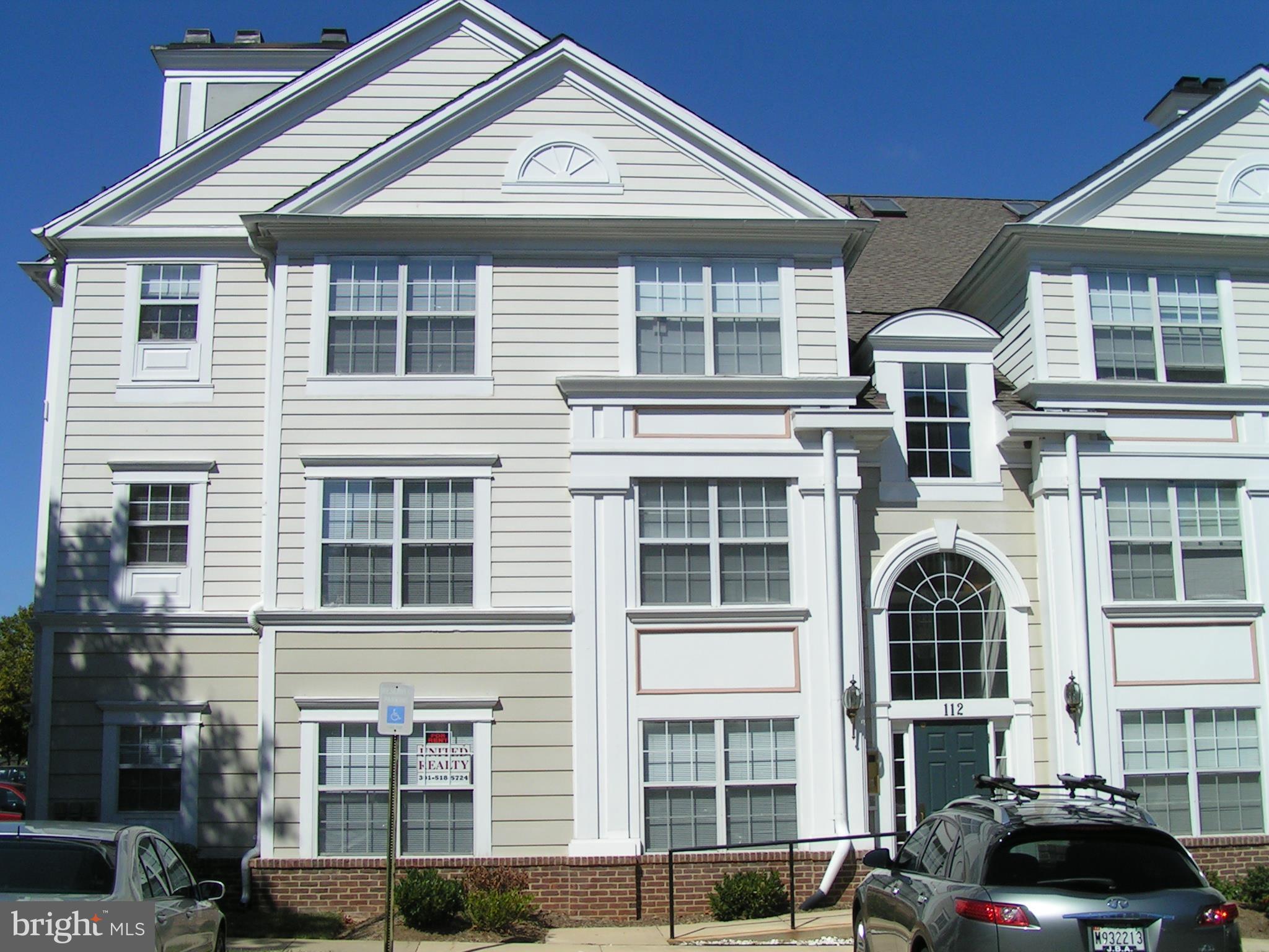 a front view of a residential apartment building with a front door
