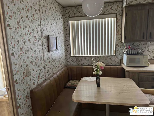 a kitchen with a table chairs and a stove