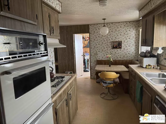 a kitchen with stainless steel appliances a stove a sink and a refrigerator