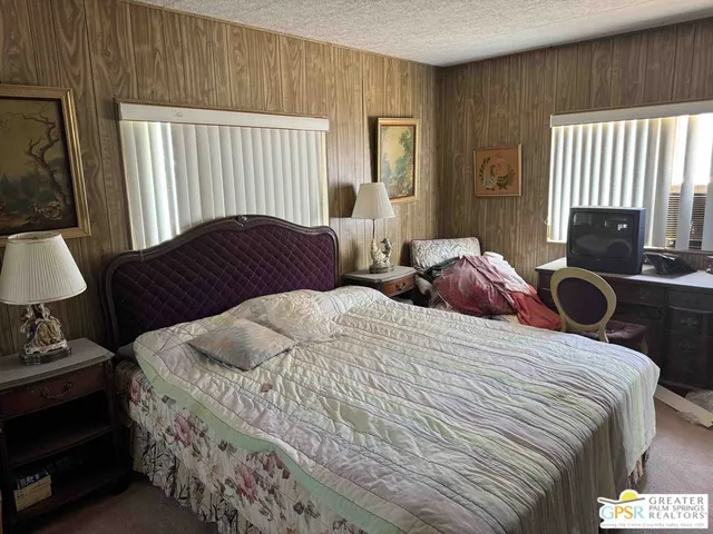 a bedroom with two beds and a window