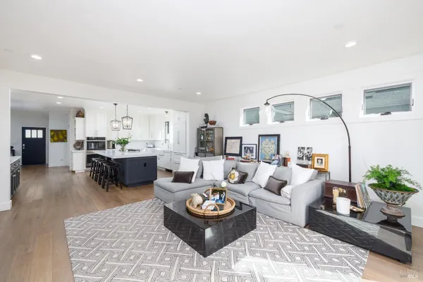 a living room with furniture and kitchen view