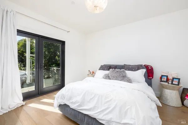 a bed sitting in a bedroom next to a large window