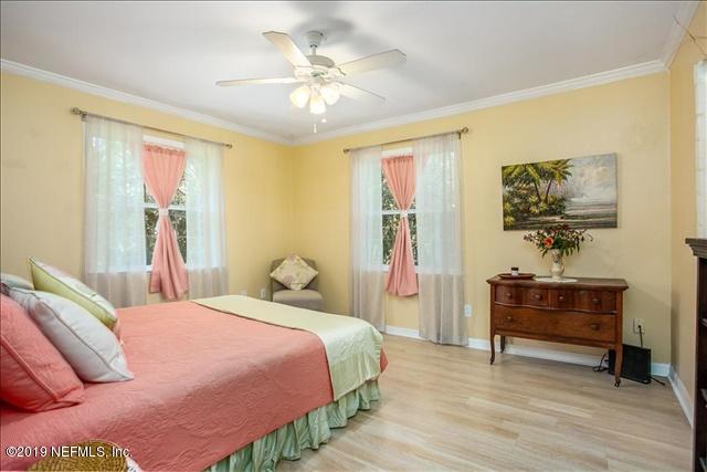 229 Dondanville Road St. Augustine, FL 32080 - Photo 15 of 22 a bedroom with a bed and a chandelier