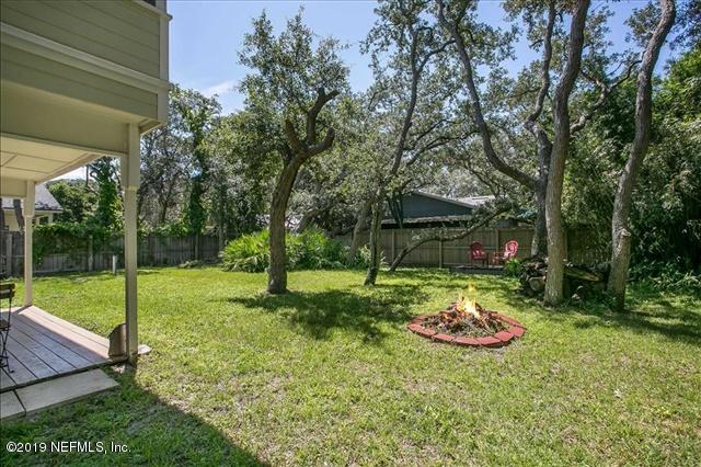229 Dondanville Road St. Augustine, FL 32080 - Photo 21 of 22 a view of a backyard with table and chairs and large tree