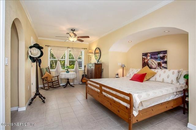 229 Dondanville Road St. Augustine, FL 32080 - Photo 5 of 22 a bedroom with a bed and a chandelier