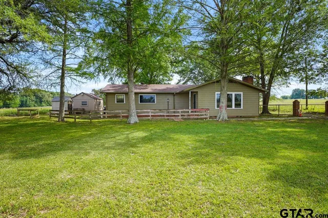 a view of house with a yard
