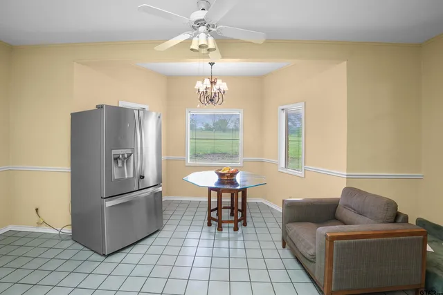 a living room with furniture a table and chairs