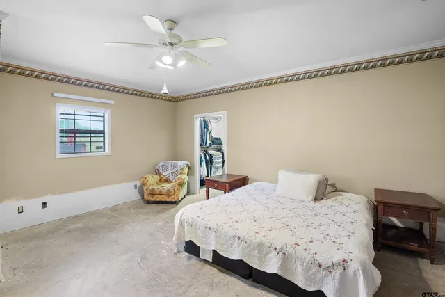 a bedroom with a bed and window