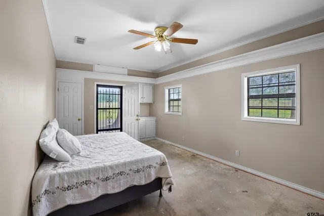 a bedroom with a bed and window