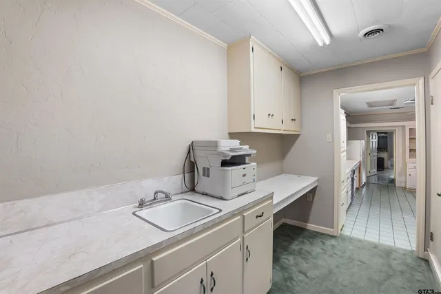 a utility room with sink dryer and washer