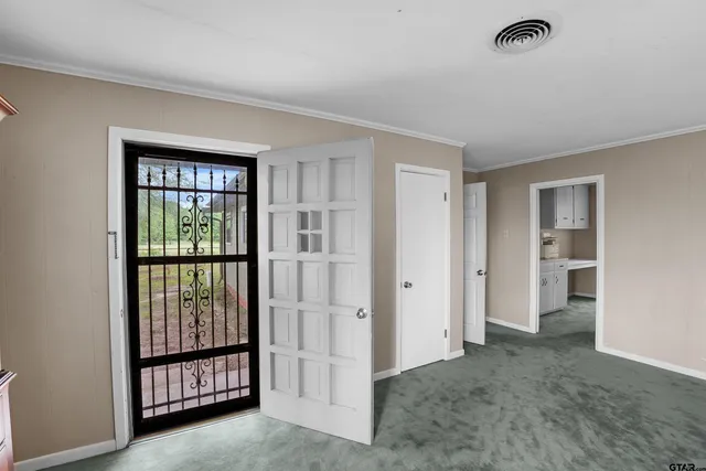 an empty room with fireplace and windows