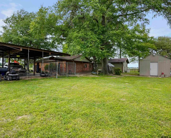 a house view with swimming pool in front of it