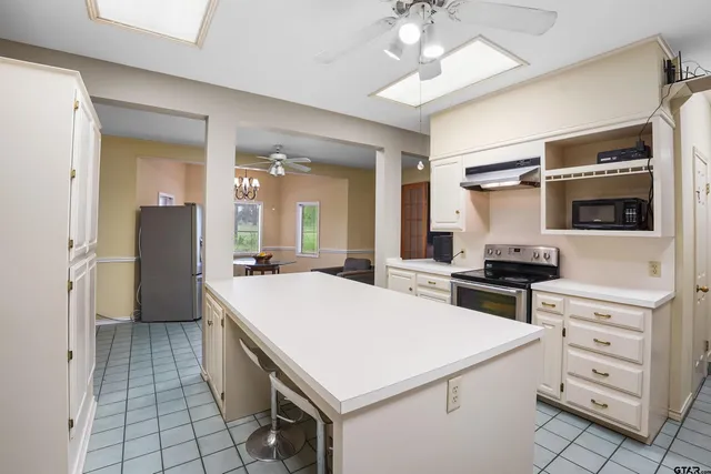 a kitchen with a stove a sink and a refrigerator