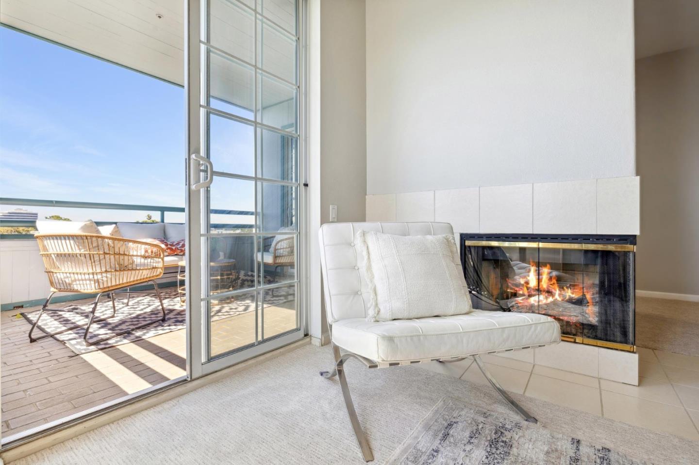 720 Promontory Point Lane, Unit 2305 Foster City, CA 94404 - Photo 36 of 78 a living room with a fireplace furniture and a floor to ceiling window