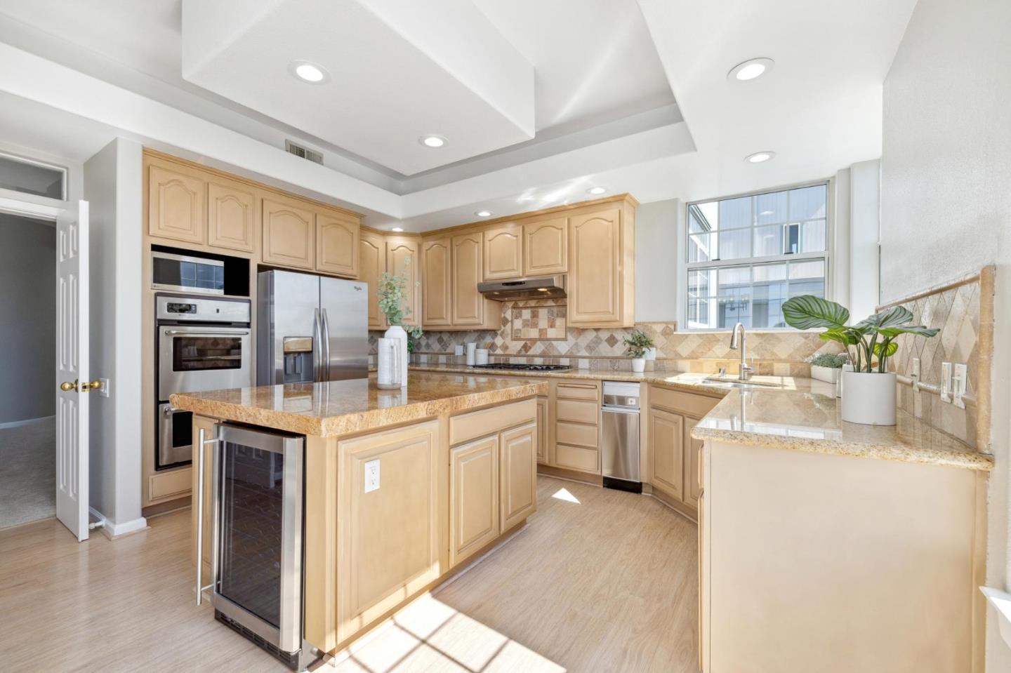 720 Promontory Point Lane, Unit 2305 Foster City, CA 94404 - Photo 41 of 78 a kitchen with stainless steel appliances granite countertop a refrigerator sink stove and oven