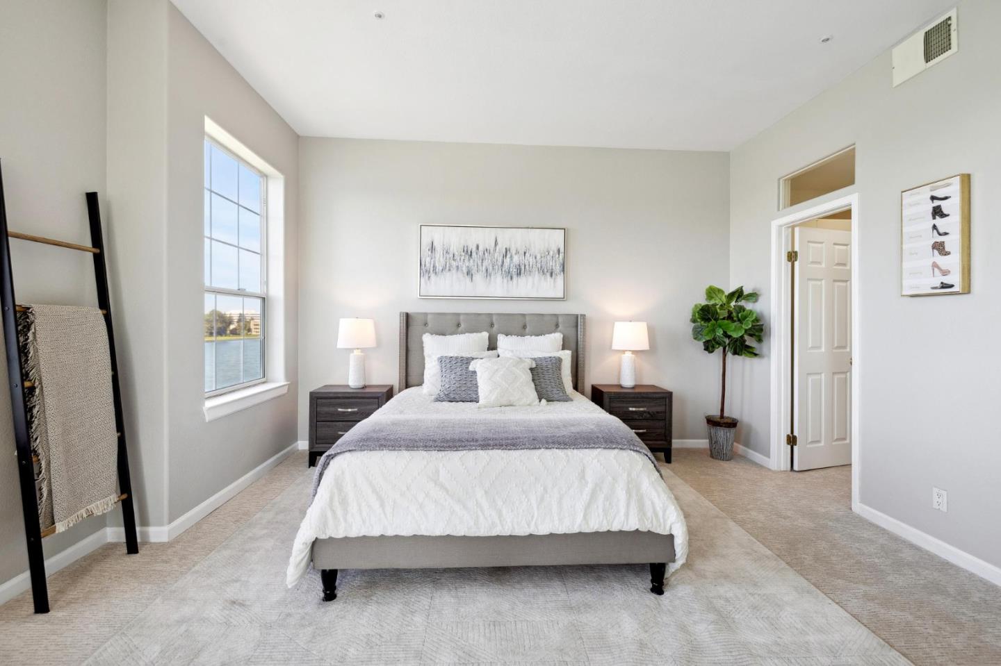 720 Promontory Point Lane, Unit 2305 Foster City, CA 94404 - Photo 50 of 78 a bedroom with a large bed and a potted plant