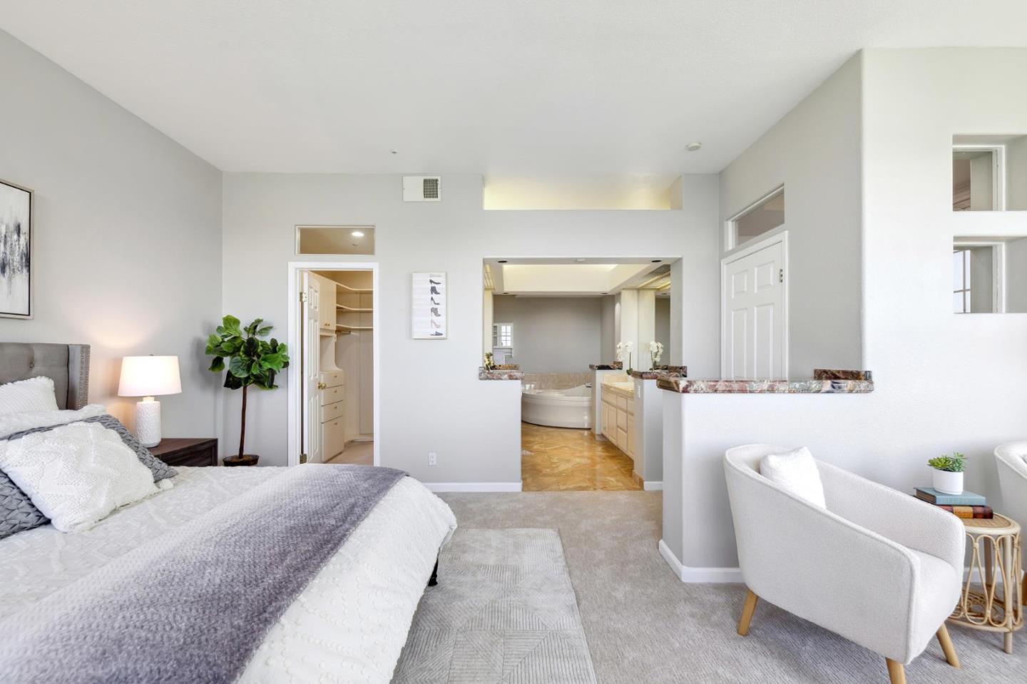 720 Promontory Point Lane, Unit 2305 Foster City, CA 94404 - Photo 51 of 78 a bedroom with a large bed a couch and potted plant