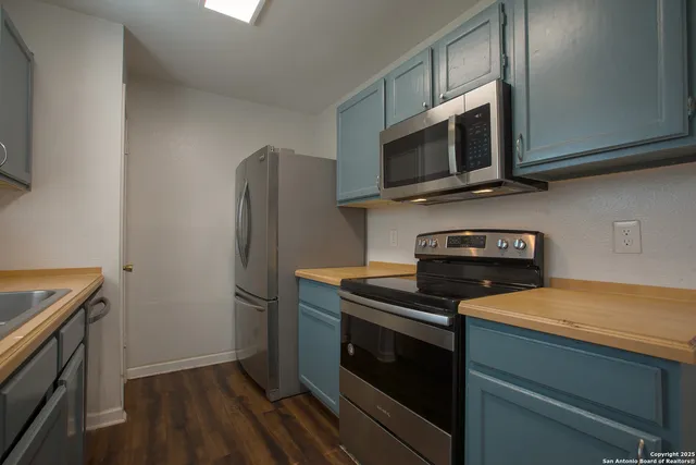 a kitchen with a sink and wooden cabinets