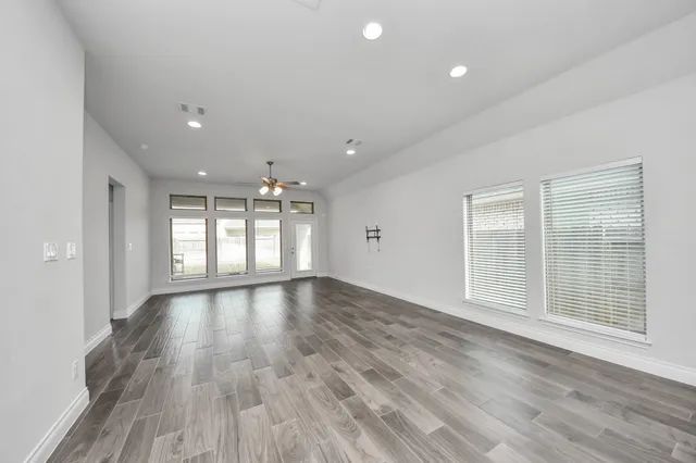 a view of an empty room and wooden floor