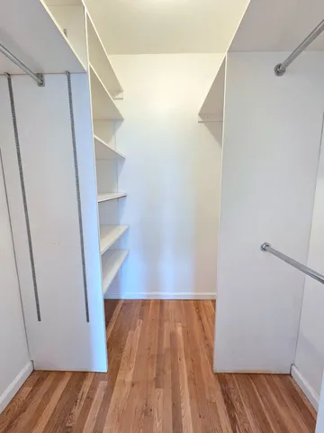 a view of a room with wooden floor