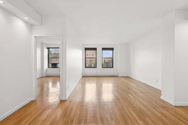 an empty room with windows and closet